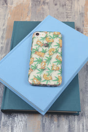 Lightly Toasted Cat and Leaf Print iPhone Case on top of books 