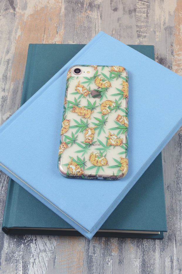Lightly Toasted Cat and Leaf Print iPhone Case on top of books 