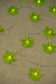 Lightly Toasted Leaf String Lights close up on leaf lit up 