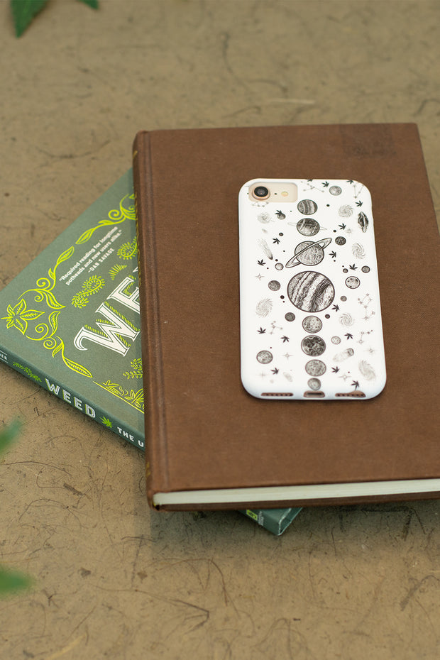 Lightly Toasted Planetary iPhone Case on pile of books 